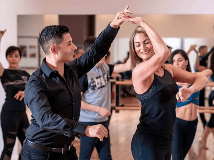 Dancers doing an underarm turn in a class