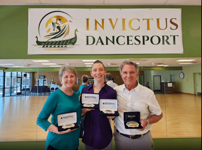 Stacey standing between two students who earned buckle rewards in Montana