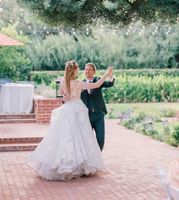 A wedding couple dancing together.